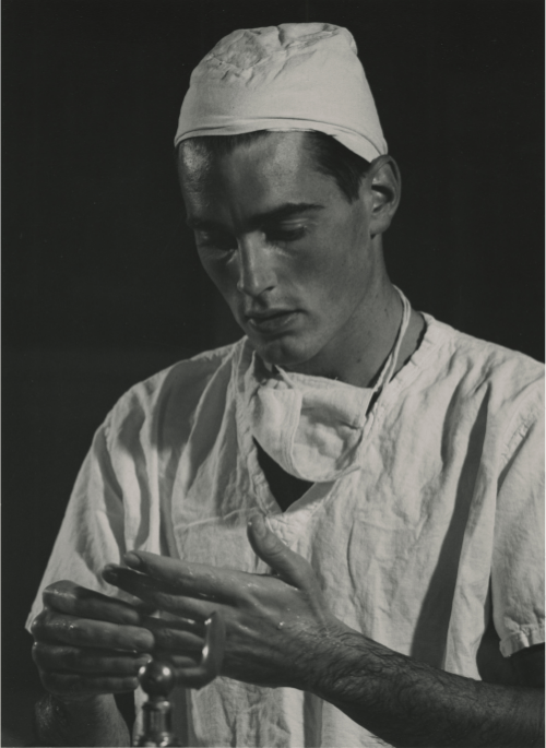 Black and white photo of a medical student in scrubs