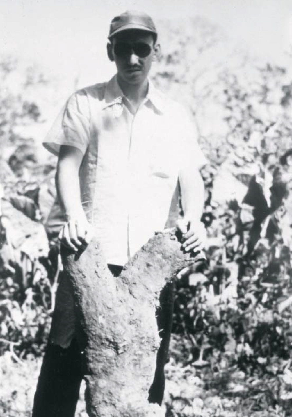 Dr. Zaffaroni in the Mexican jungle holding a yam used in drug production.