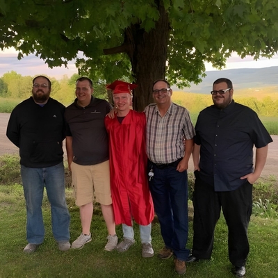 Oman (second from right) with his sons, celebrating his grandson’s high school graduation in 2020.