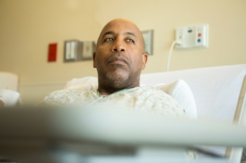 Man in hospital reflecting after a procedure