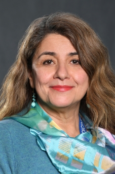 A formal headshot of Pathologist&nbsp;Gissou Azabdaftari, MD, wearing a light blue sweater and a lighter blue scarf around her neck.