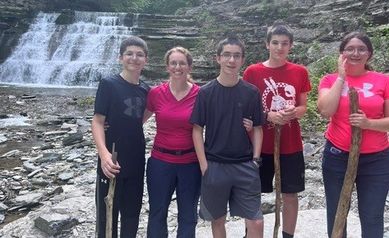 Carr/Gracioso family of 5 standing near waterfall