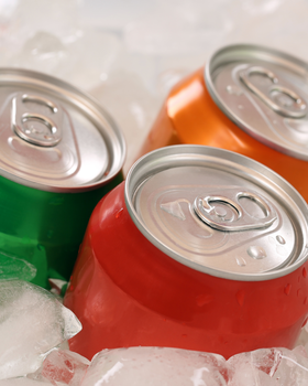 three cans of beverages in ice