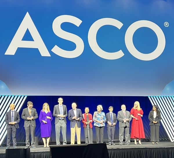 Louis Constine (fourth from right) stands on stage with other 2026 ASCO Special Award recipients.
