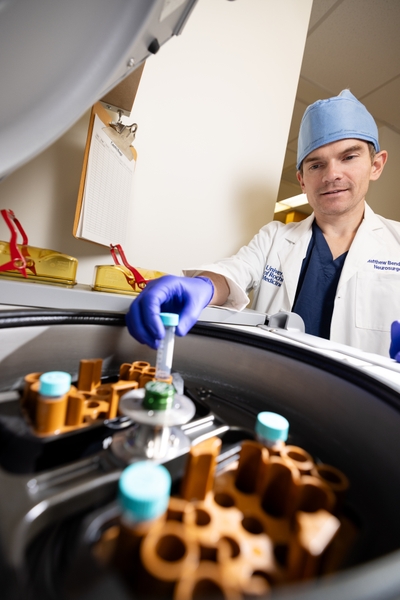 clinician scientist works with blood samples in lab
