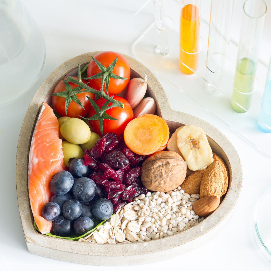 heart shaped dish with healthy food and fruit in it.