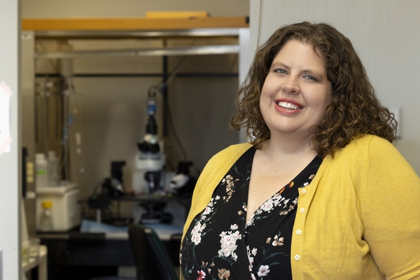 Researcher poses in lab