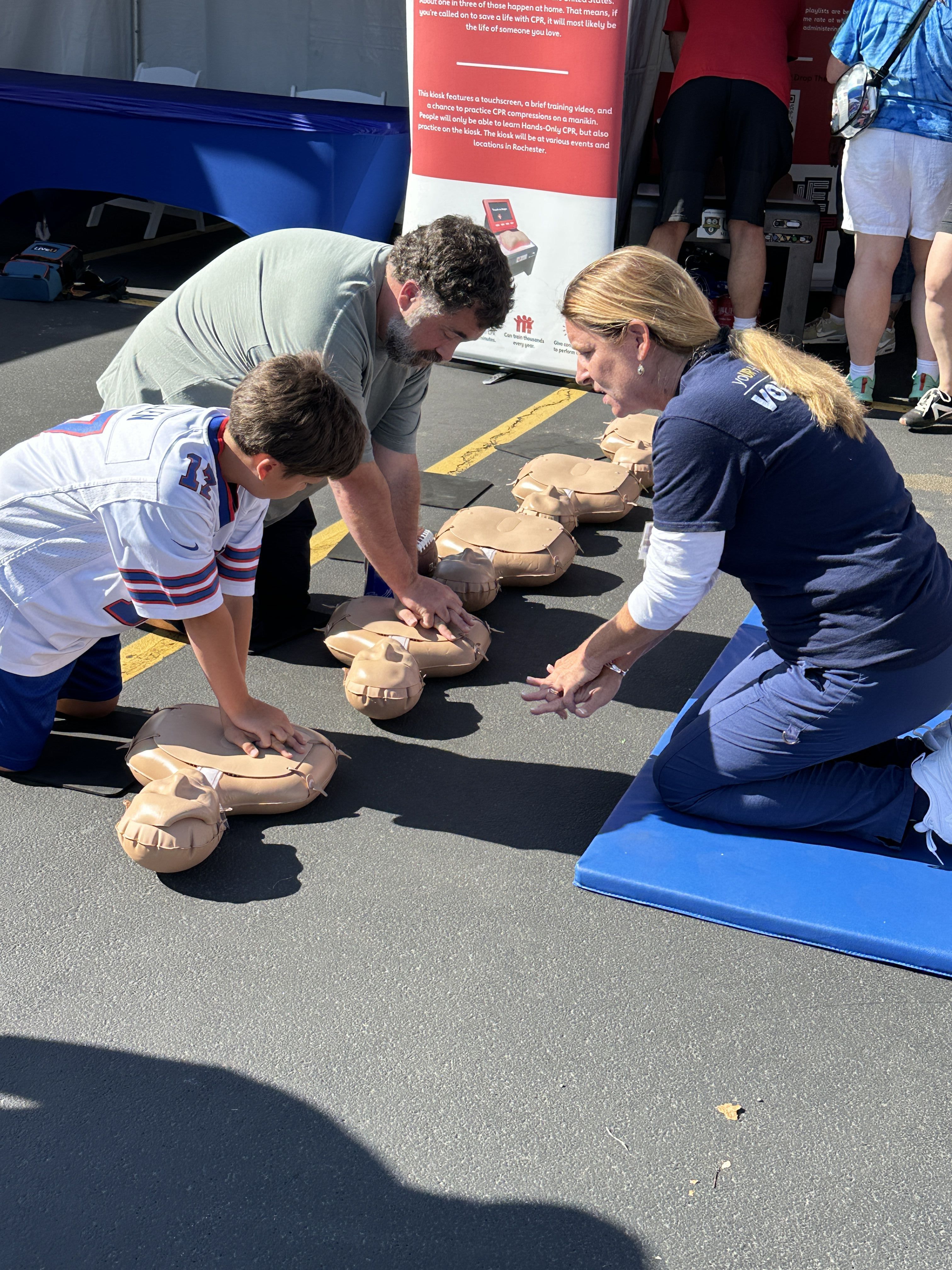 Father and son learn CPR