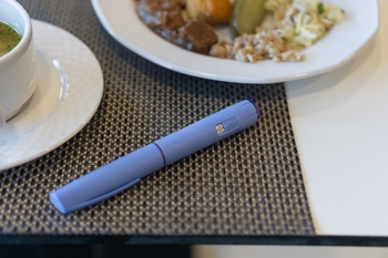 GLP-1 injection next to food on a table