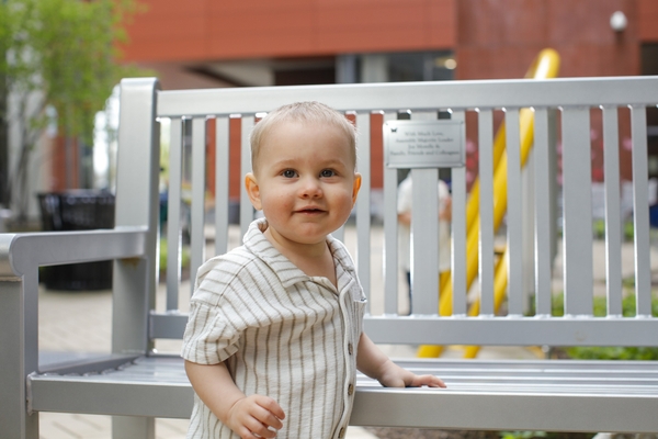 Hunter Kahl stands in front of a bench and gives a calm smile for the camera. 