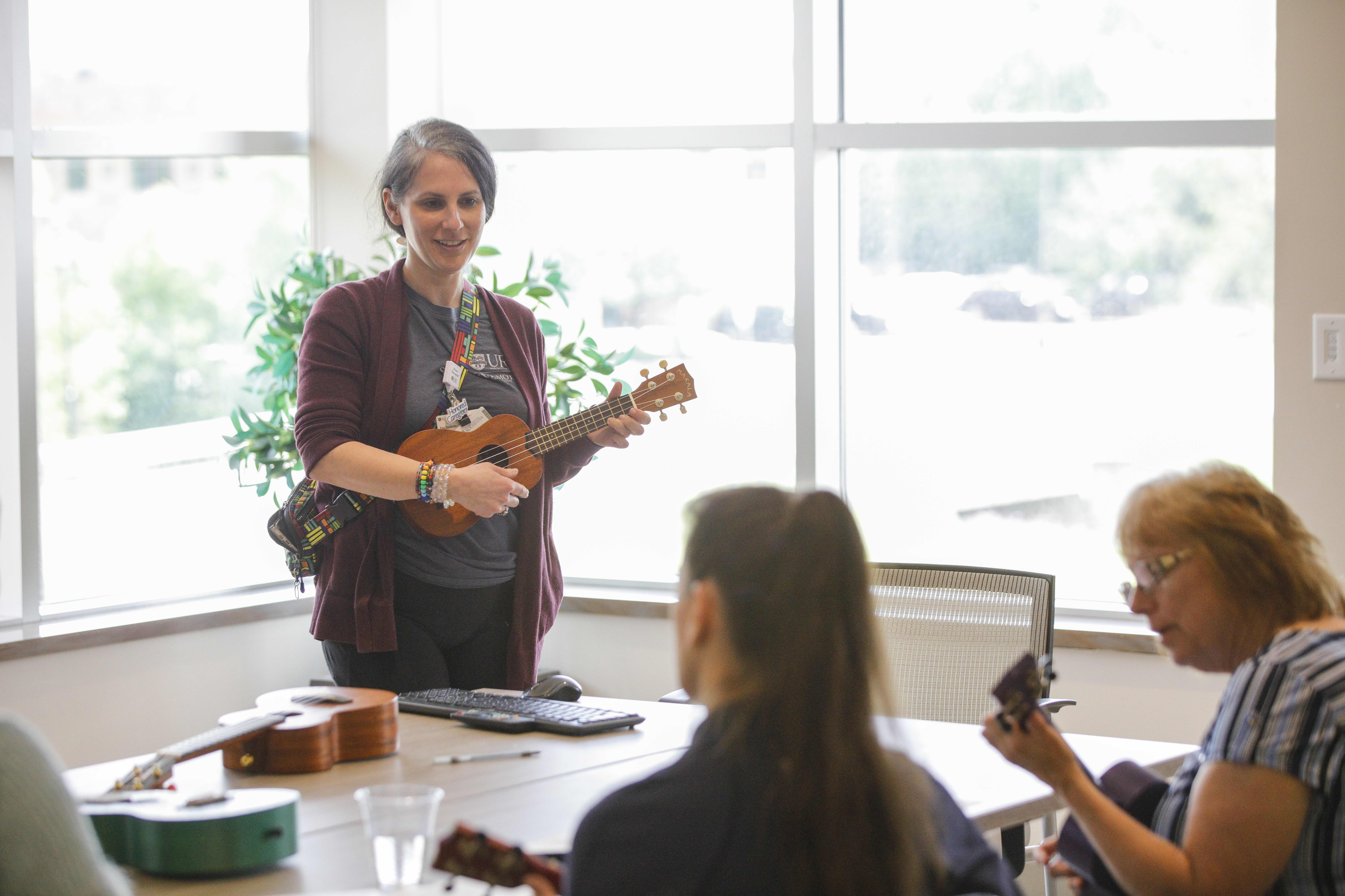 Music therapist Leigh A. Kirby leads a music class at the Integrative Oncology Center.