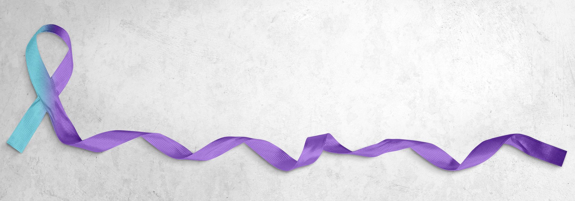 blue and purple ribbon representing suicide prevention