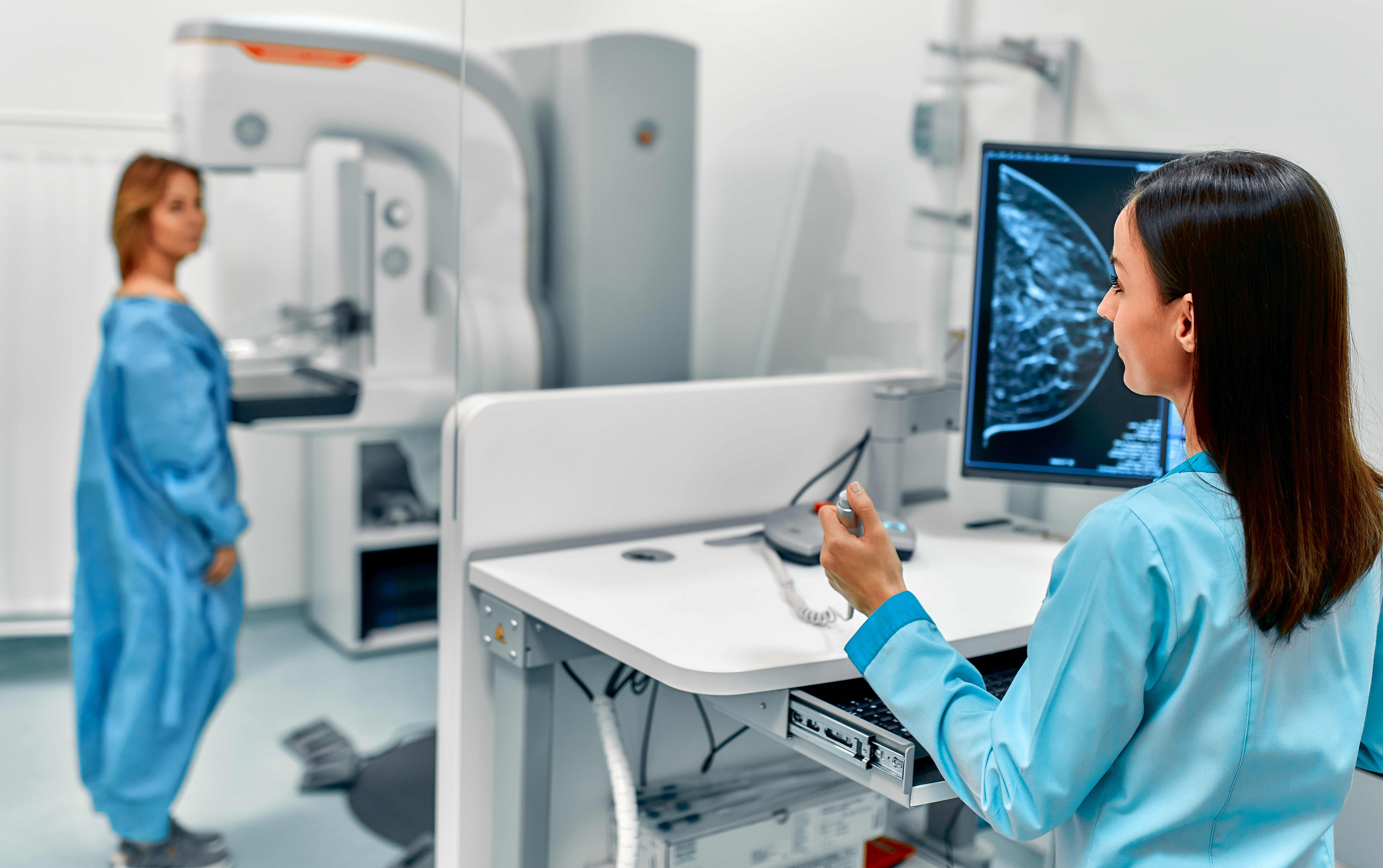 A doctor reviews a mammogram image