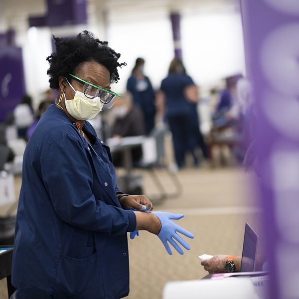 covid vaccine Black team member at event