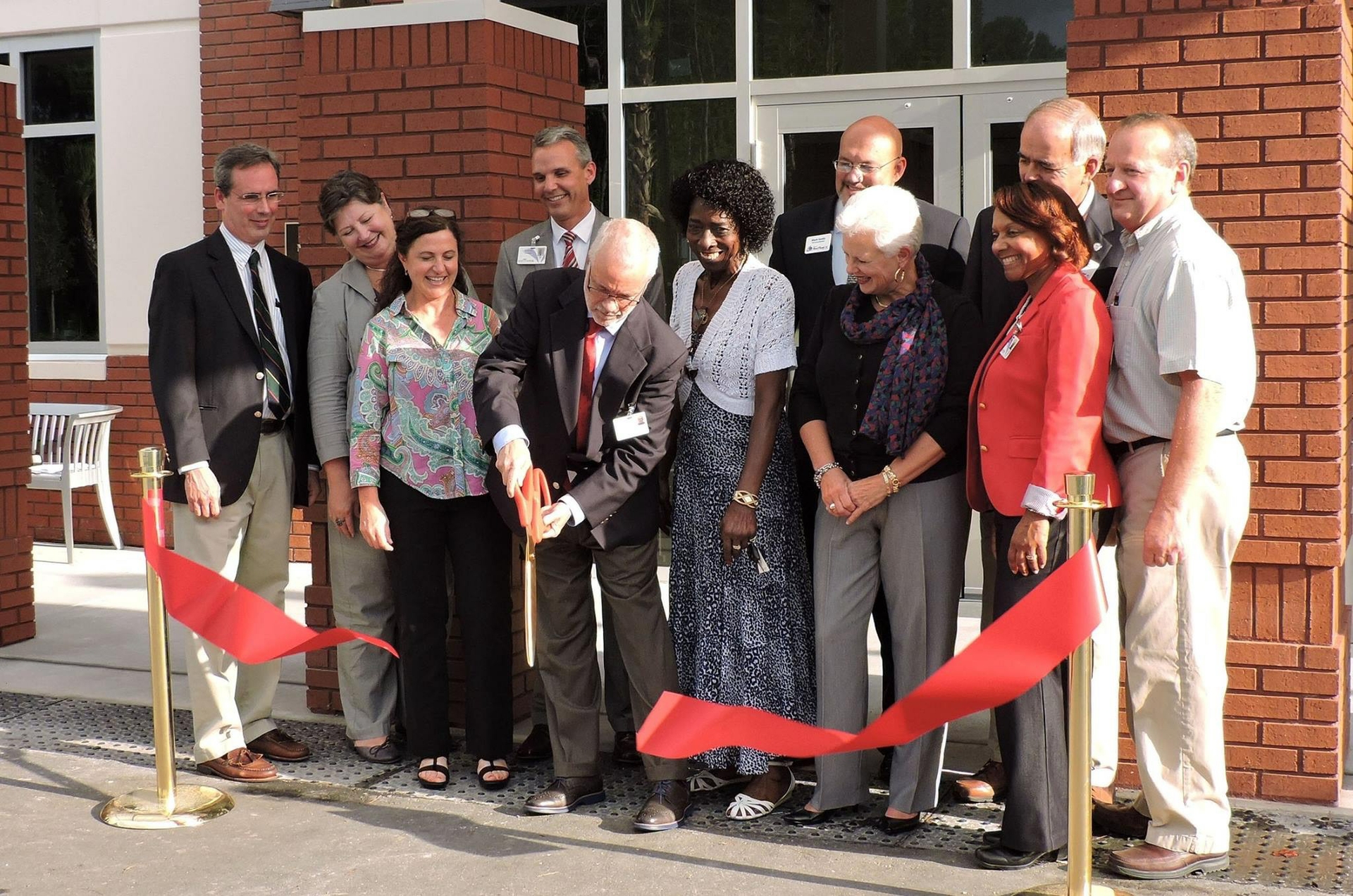 Danny Mullis cutting ribbon at Mullis Building