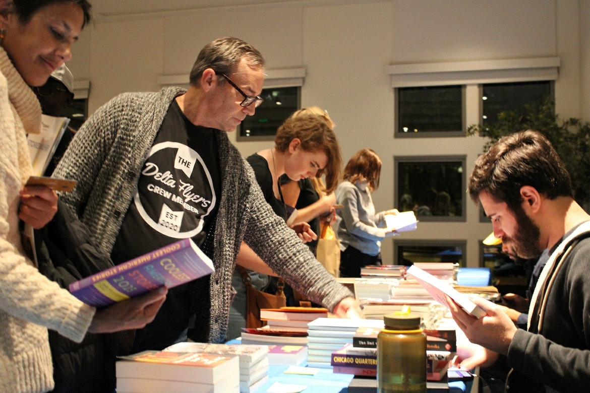 People picking out books and reading/skimming them.