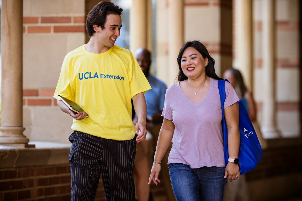 UCLA Extension Alumni and another student walking on UCLA Campus.