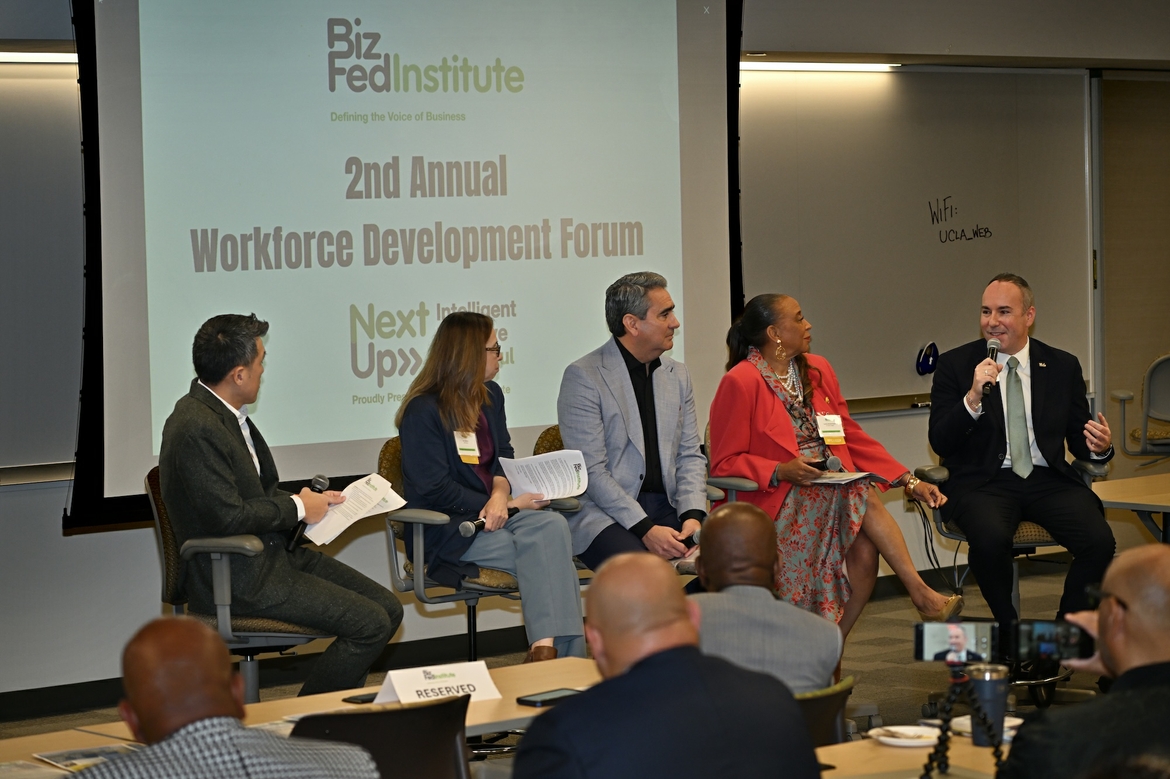 Four panelists talk with Dean Eric Bullard at the BizFed workforce development forum