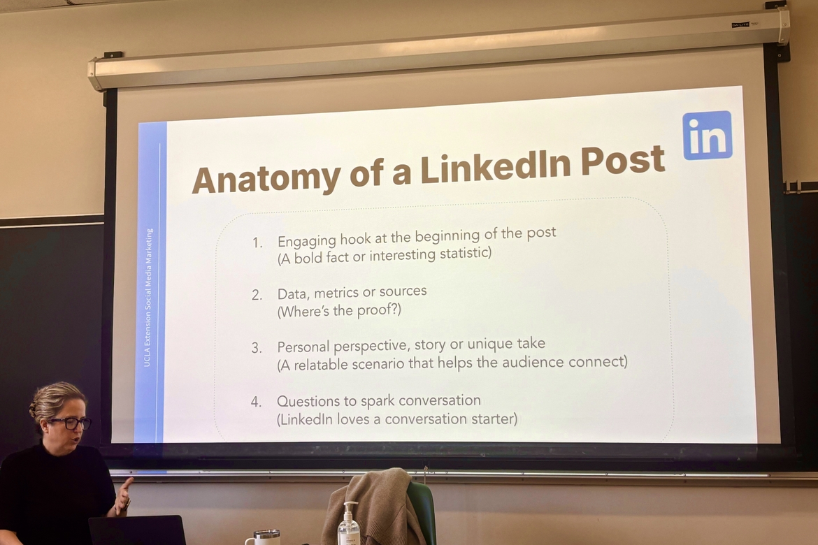 Lia Haberman at the front of a classroom showing a PowerPoint