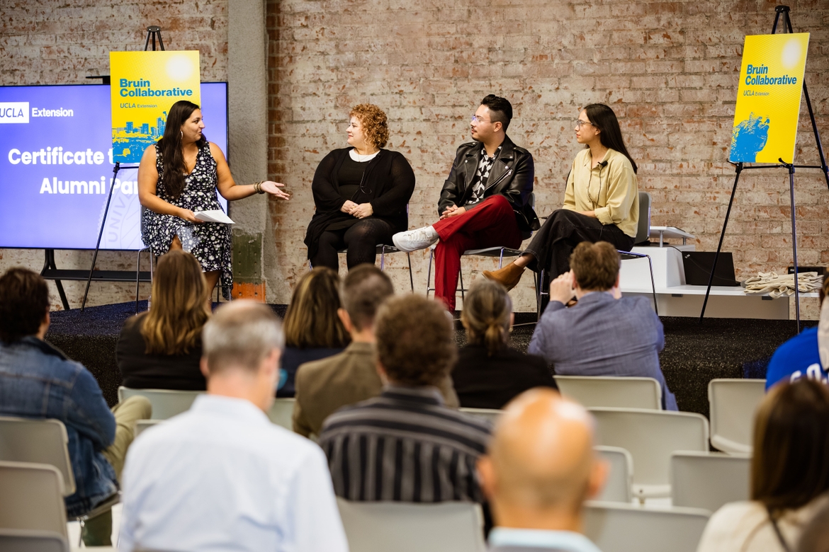 A moderator and panelists talk in the Bruin Collaborative event space