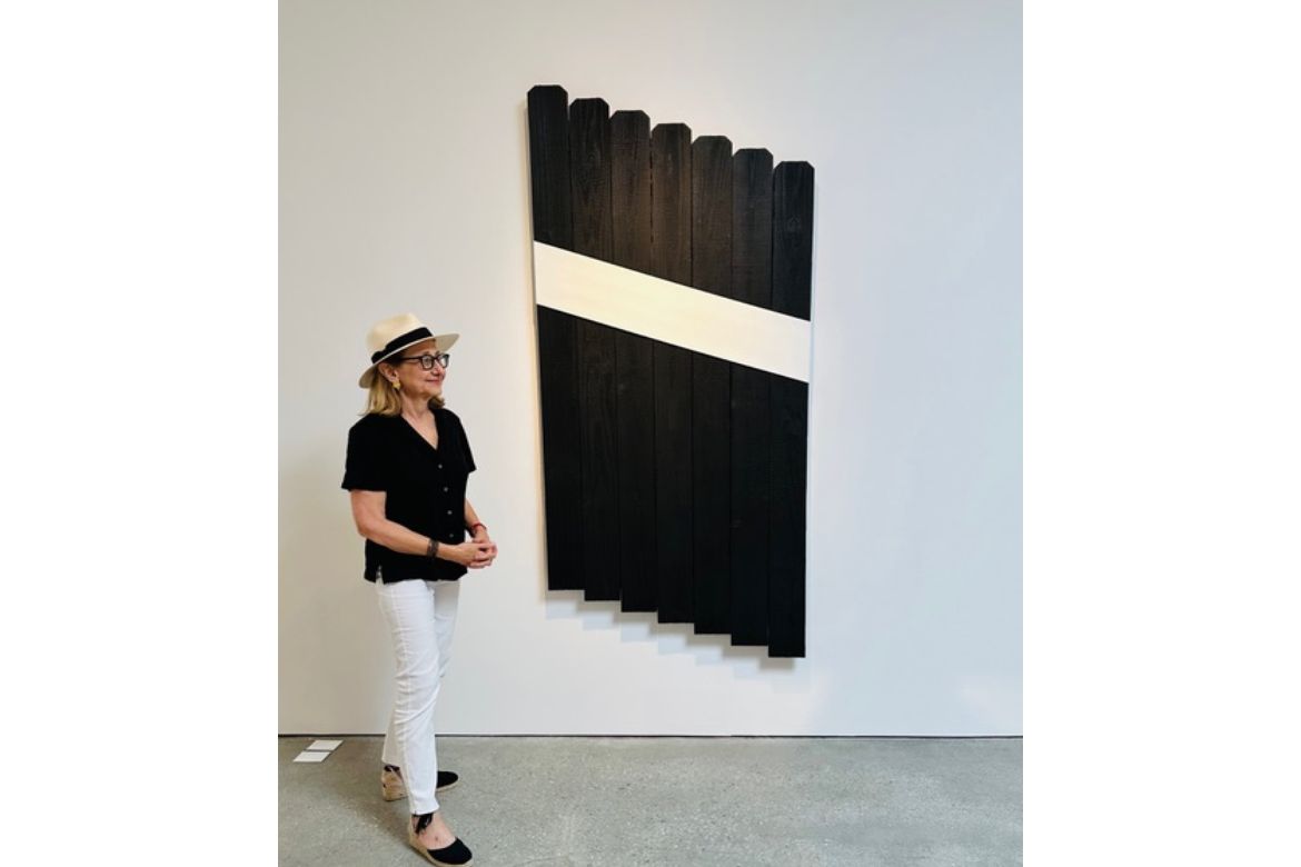 Melissa Pugash to the side of a painting