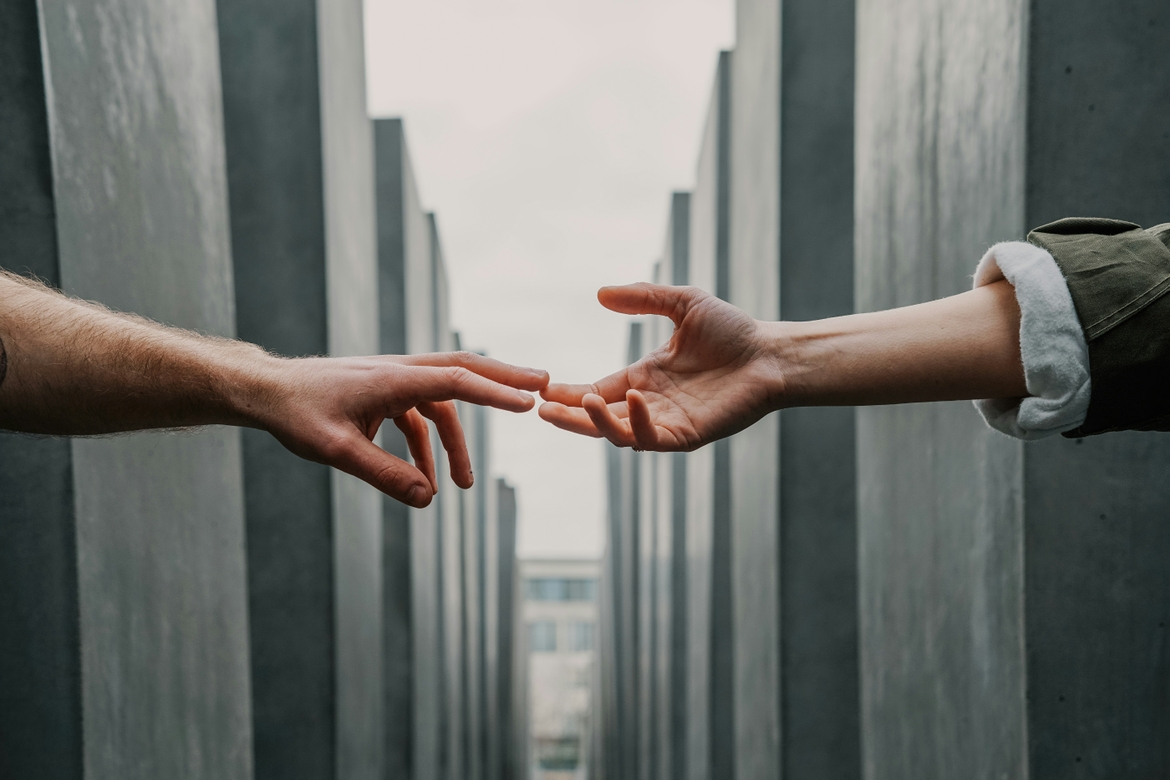 Two hands outstretching to each other