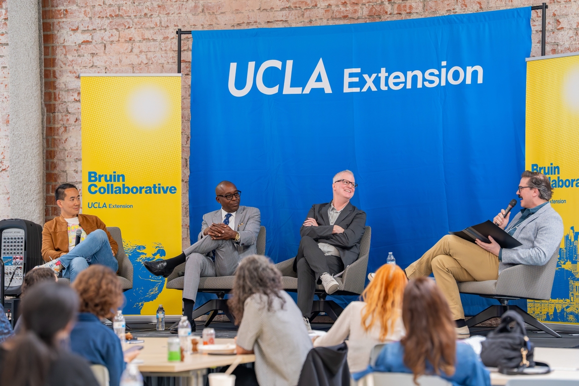 Three Future Forward panelists laugh with the moderator on stage