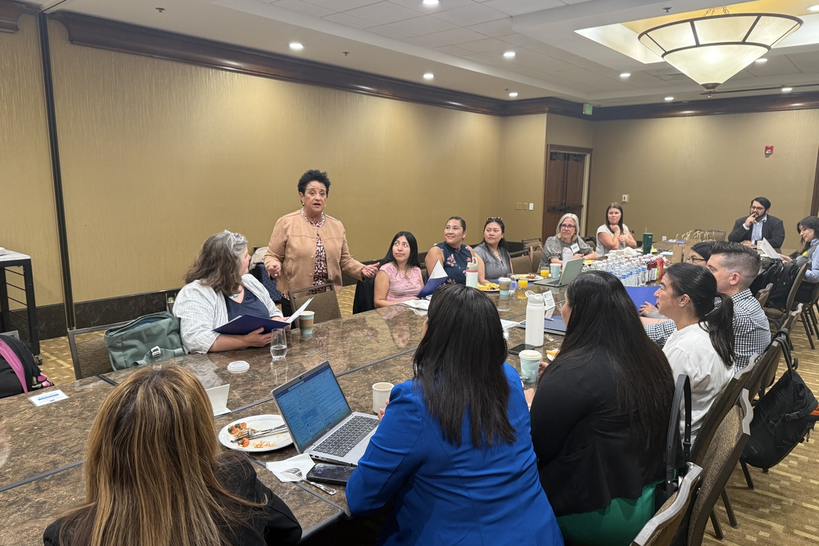 Esther Hugo addresses a crowd at breakfast