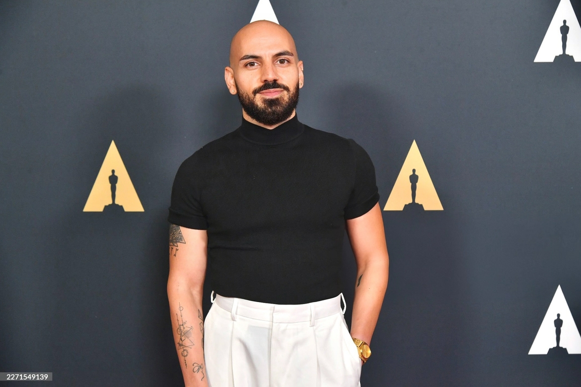 Elie El Choufany stands in front of an Academy log backdrop