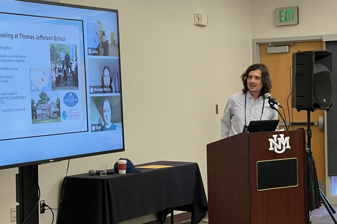 Eric Steere presents at a podium in front of a class