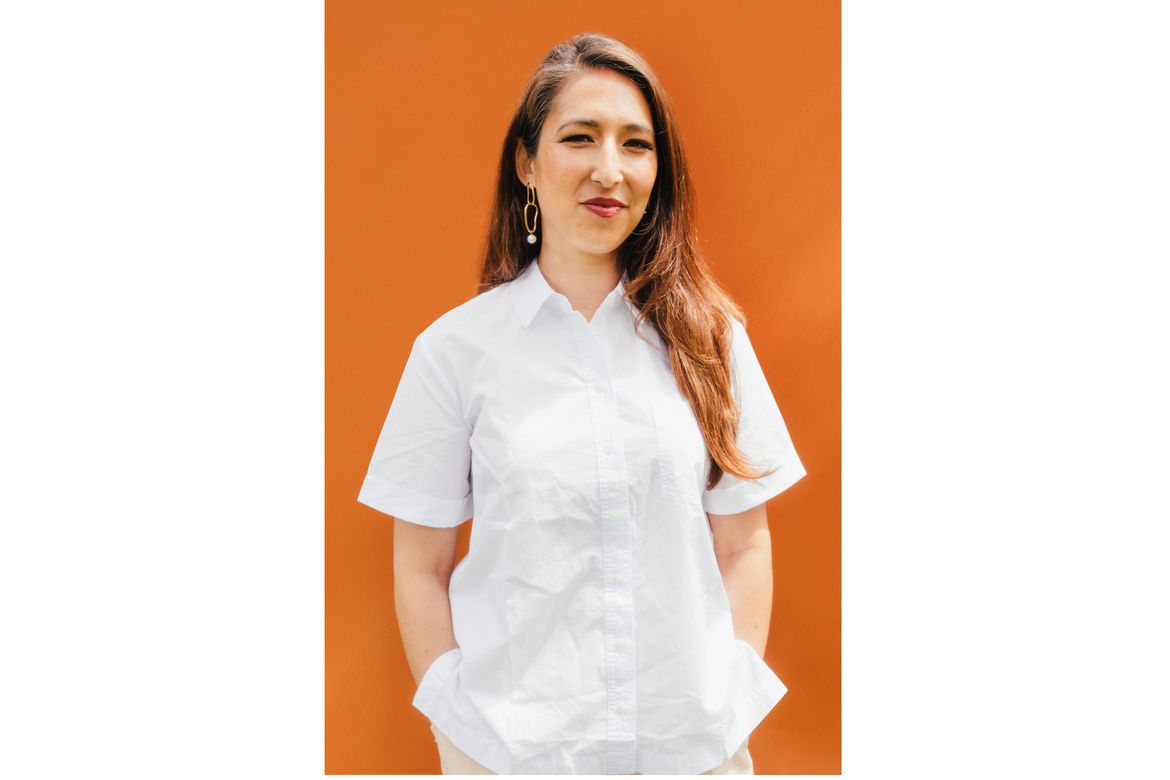 Julia Wolinsky profile shot on an orange background
