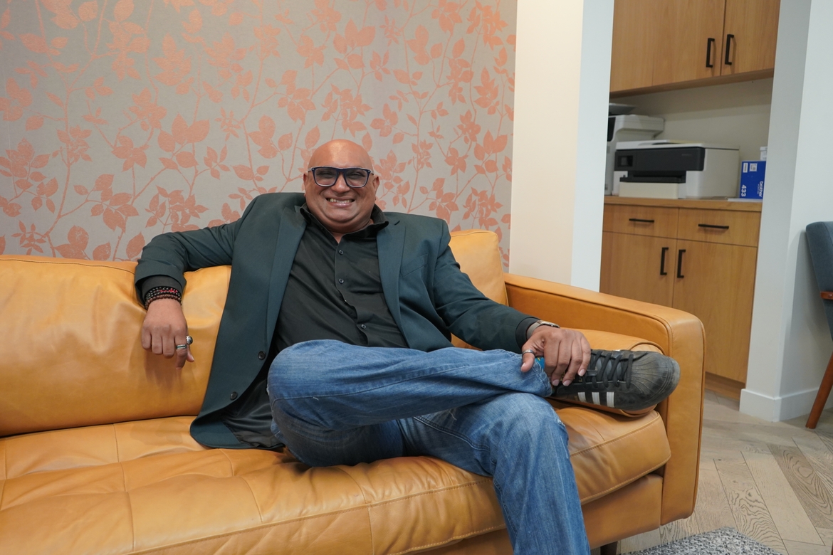 Ravi Pariah sitting on a couch