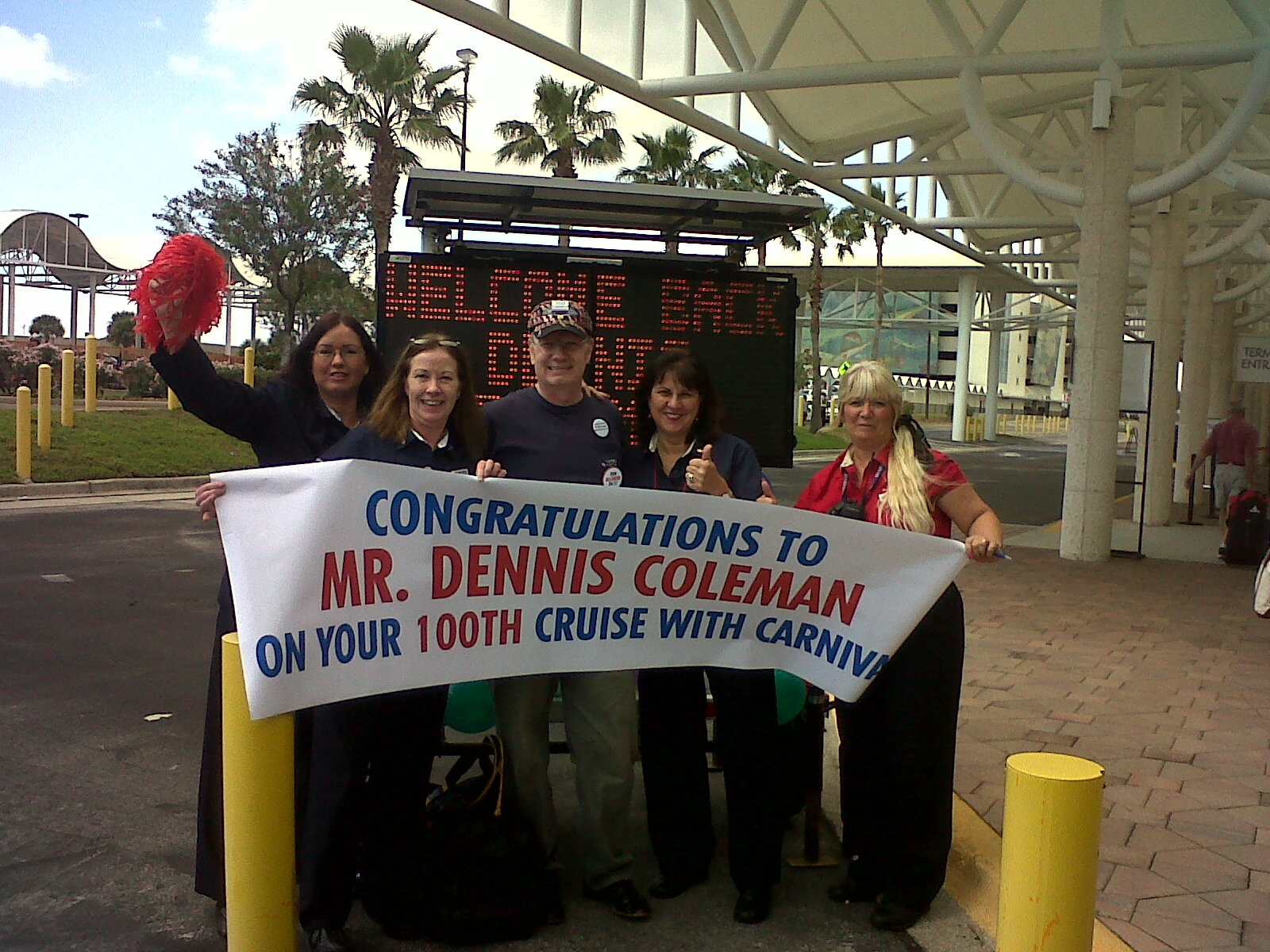 Dennis Coleman is greeted by Carnival's Port Canaveral embarkation team as he gets ready to take his 100th Carnival cruise. 