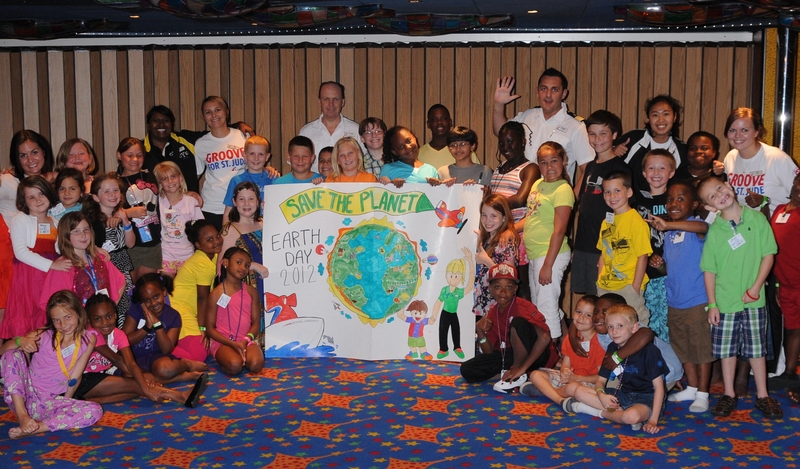 Kids participating in Camp Carnival on the Carnival Conquest show off their Earth Day Poster.