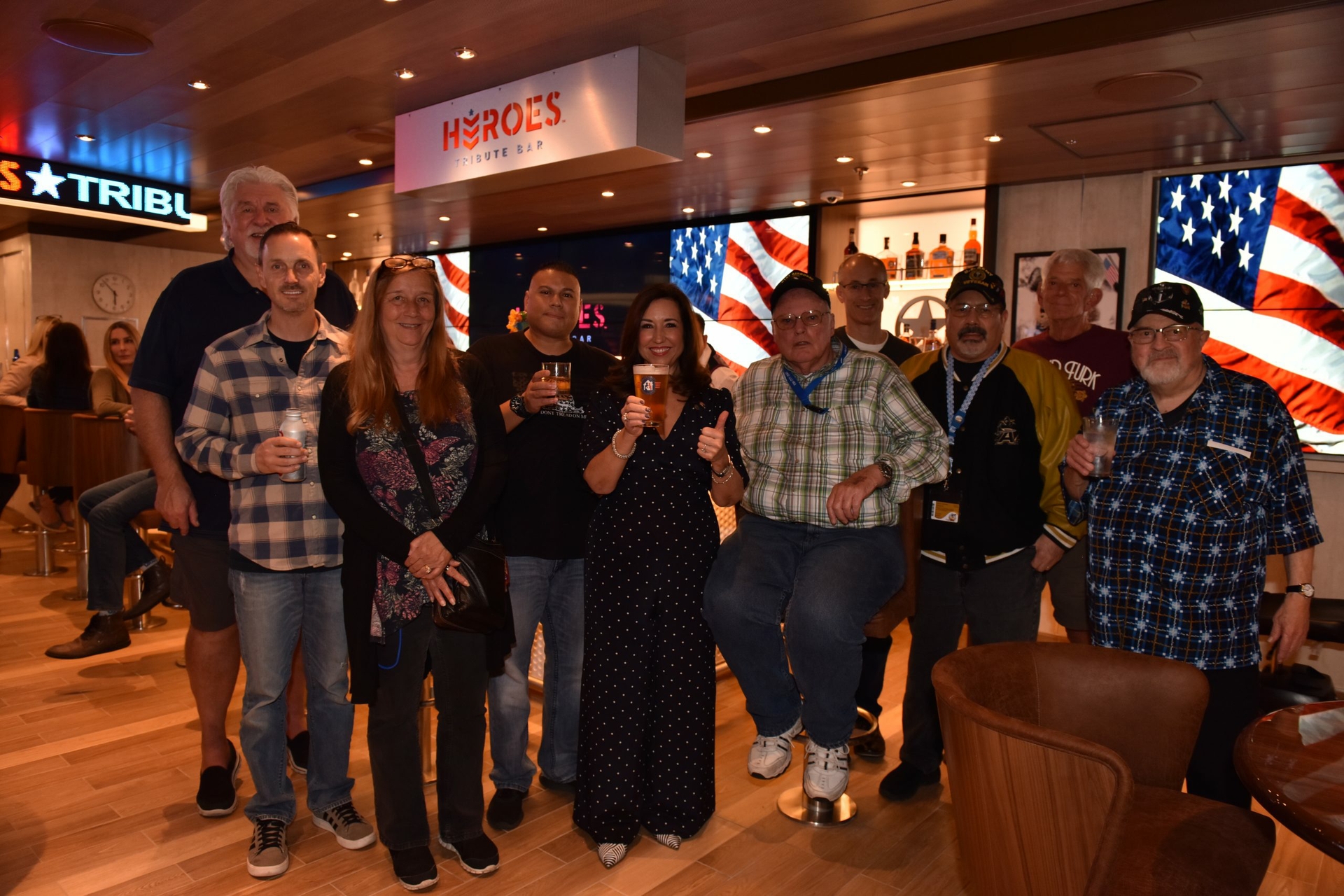 Christine Duffy with former and active military members celebrating grand opening
