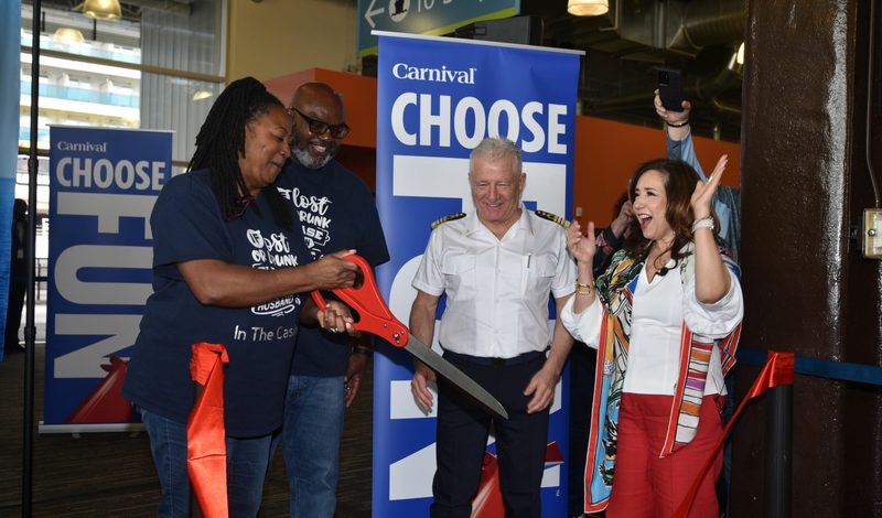 A ceremonial ribbon is cut by guests before embarking on Carnival Luminosa