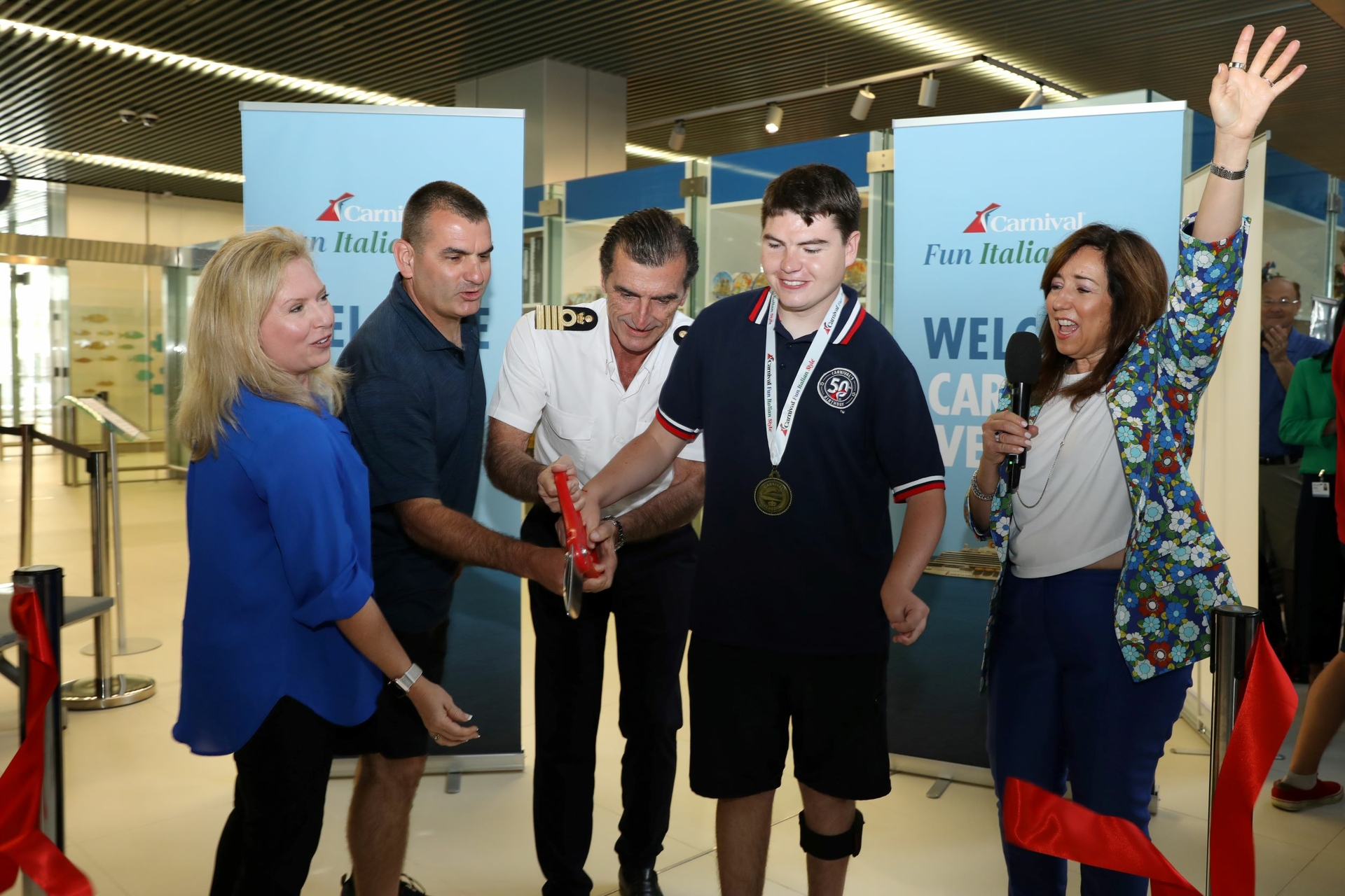 Carnival President Christine Duffy is joined by Captain Claudio Cupisti and the first family to embark on Carnival Venezia