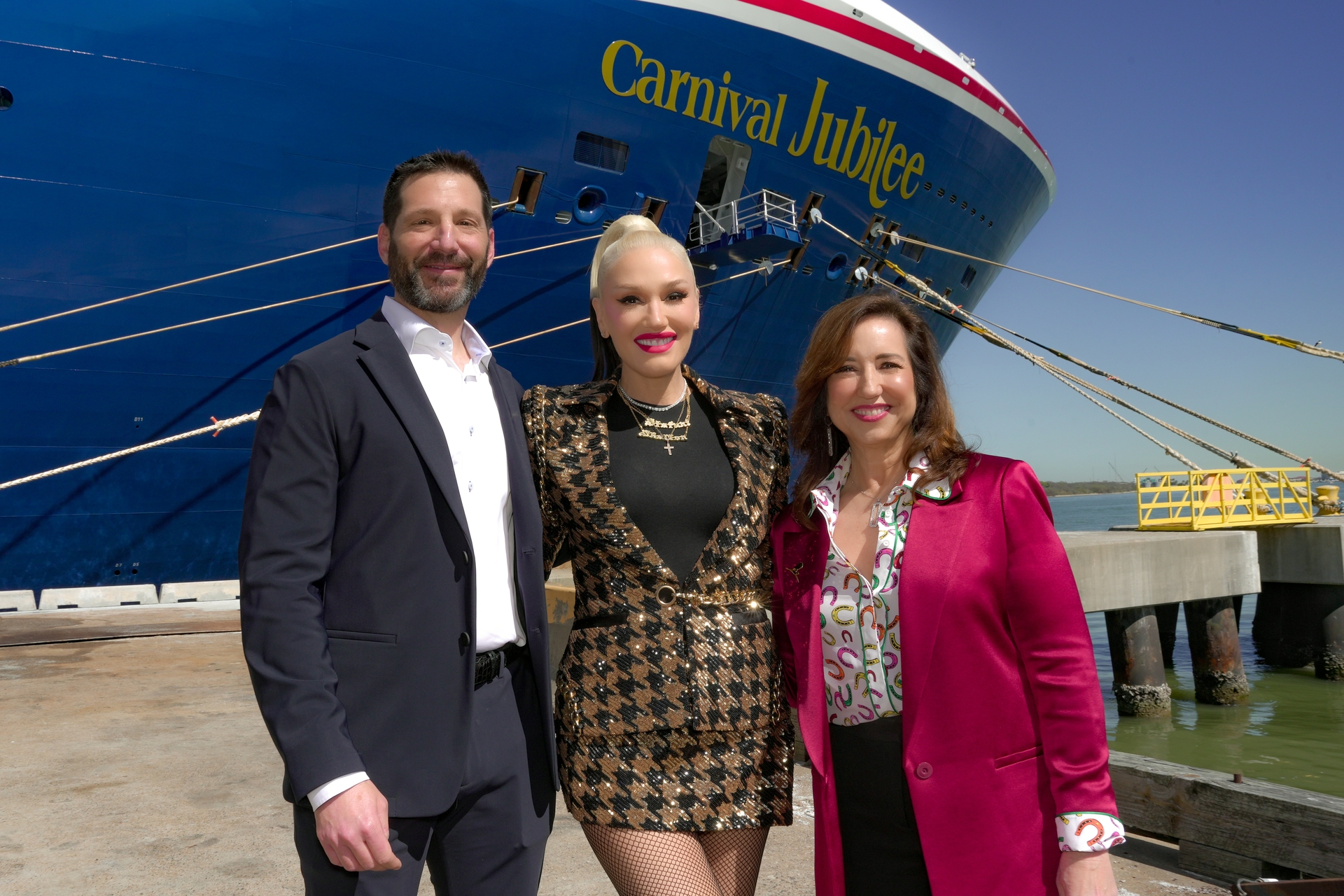 Gwen Stefani joins Christine Duffy and Josh Weinstein at the bow of Carnival Jubilee
