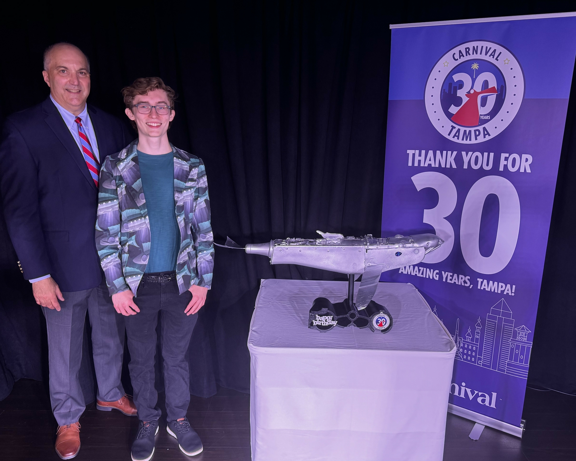 Ryan Moralevitz and Carnival Communications Officer Chris Chiames unveil special sculpture