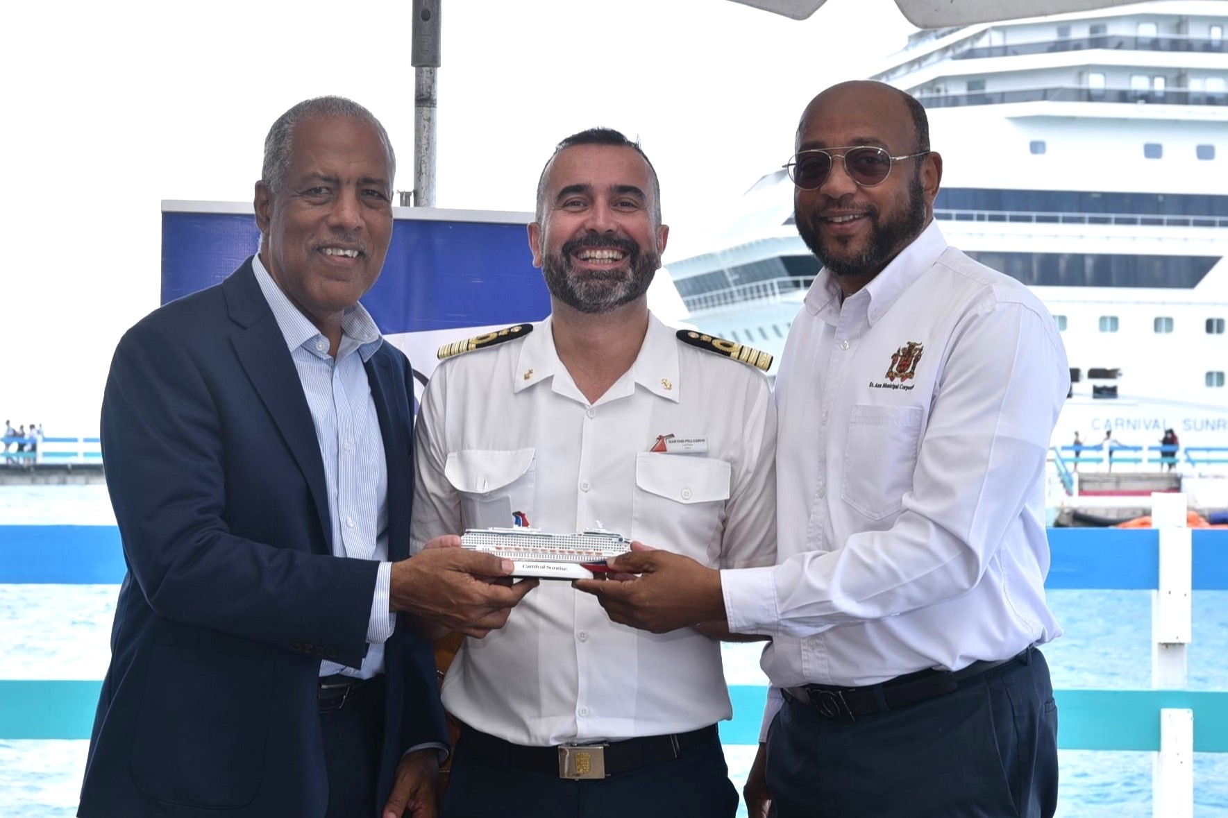 Carnival Sunrise Captain Martino Pellegrini presents model ship to President & CEO of the Port Authority of Jamaica Gordon Shirley and Mayor of St. Ann's Bay Michael Belnavis