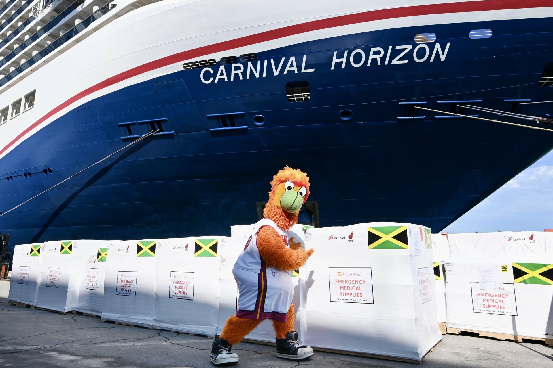 Miami HEAT Mascot Burnie poses with emergency medical supplies bound for Jamacia