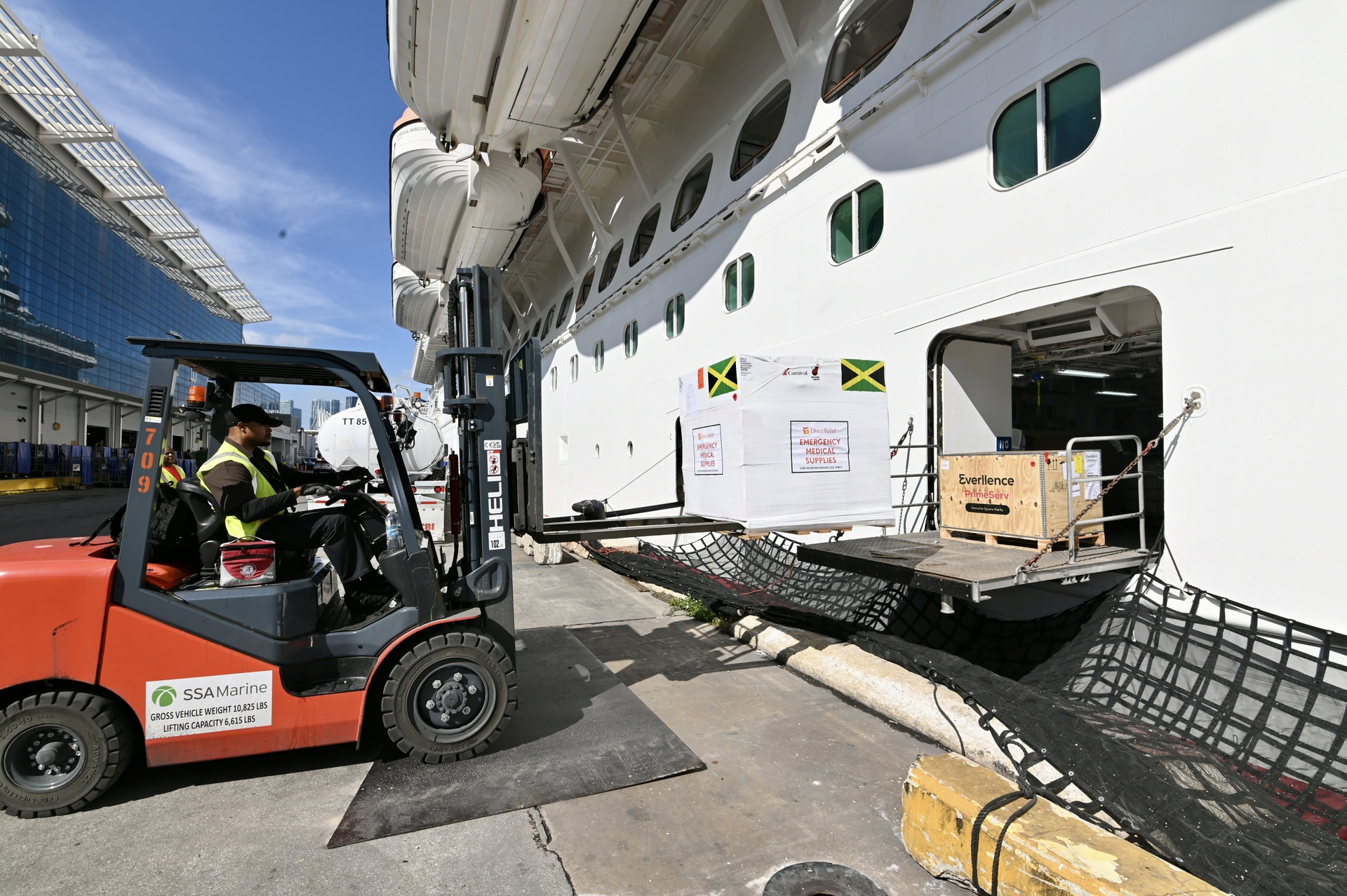 Pallets filled with emergency medical supplies for Jamacia are loaded onto Carnival Horizon