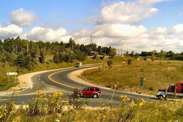 cars turning rural road
