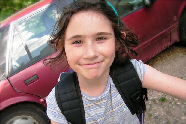girl backpack in front of car before school