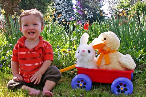 toddler with wagon stuffed easter bunny duck