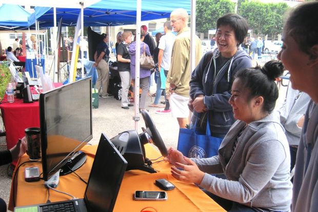 teen and mom laugh at driving simulator