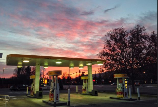 Sunrise at gas station by Don DeBold