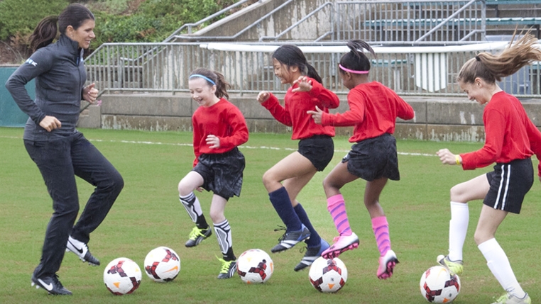 Mia Hamm plays soccer with kids
