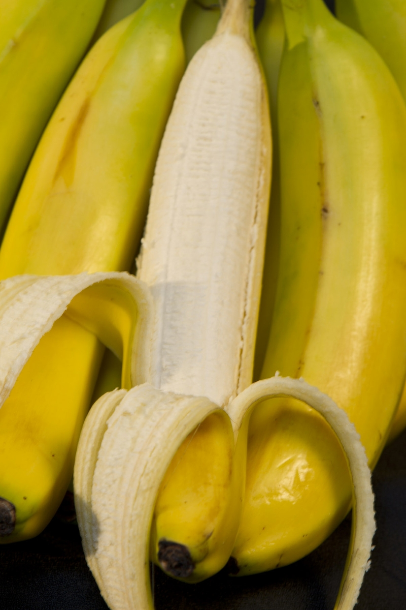 Bananas - bunch close up on peeled banana