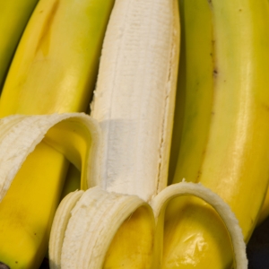 Bananas - bunch close up on peeled banana